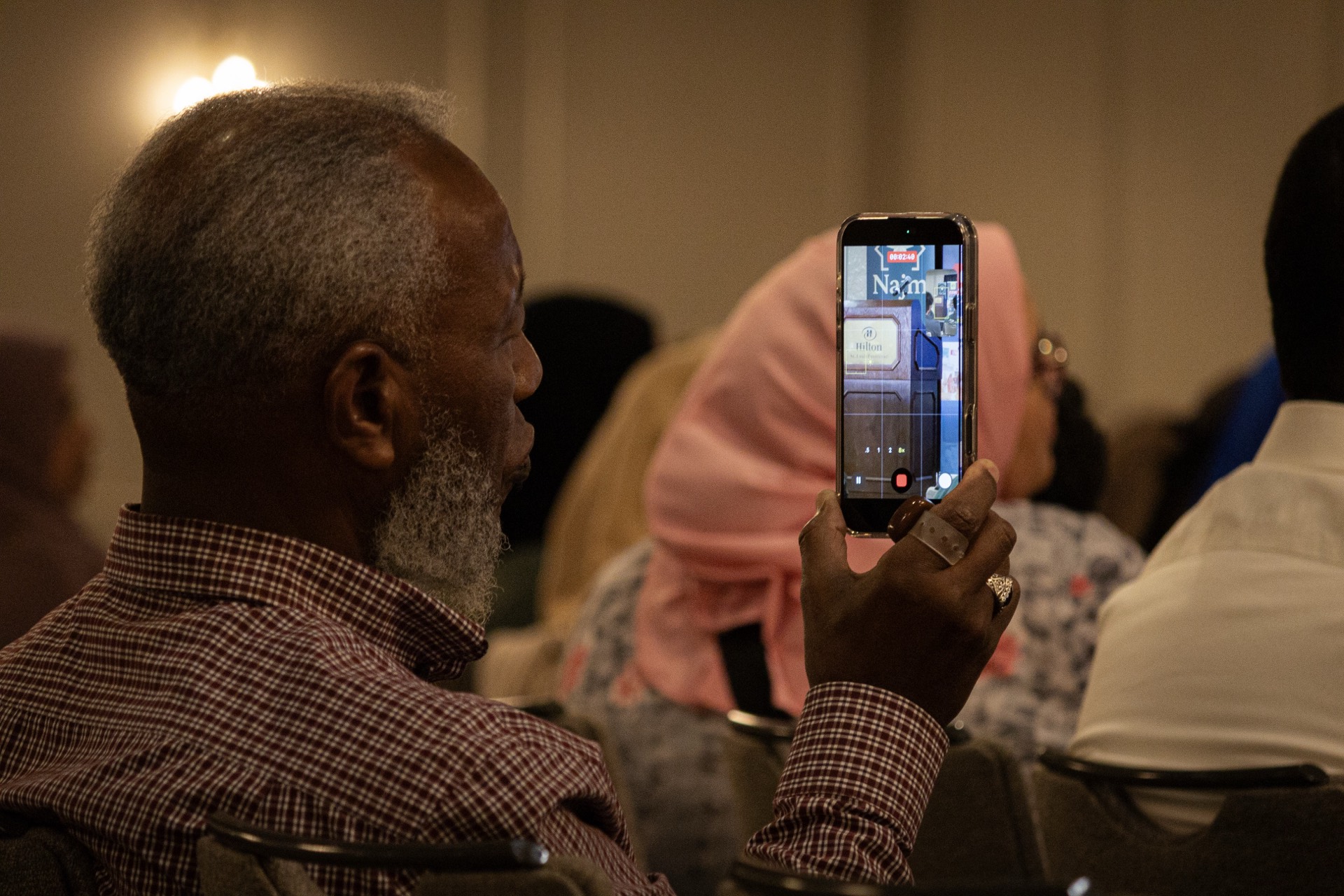 Attendee capturing the Najm x SLU MSA program