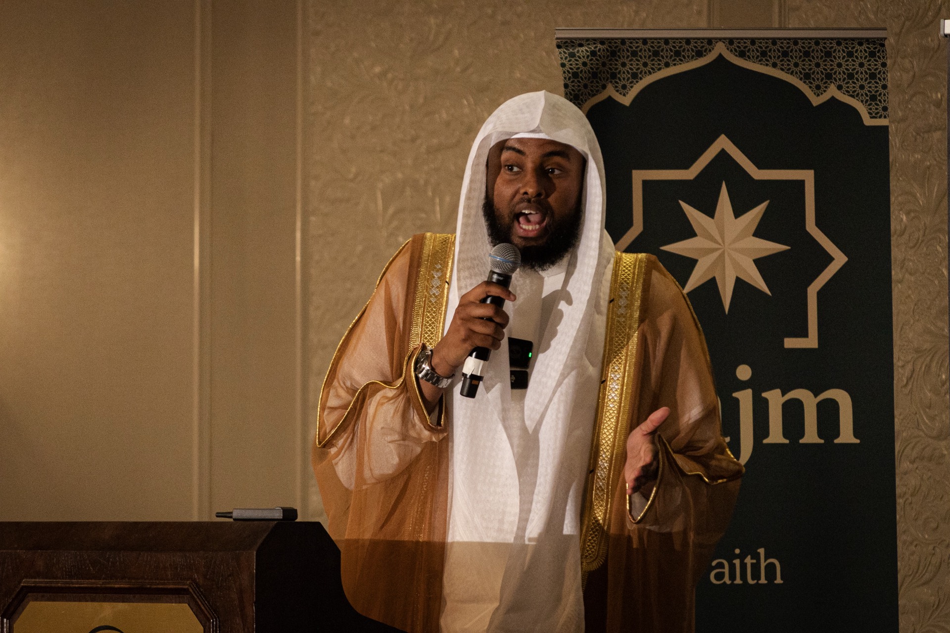 Speaker with Najm banner at the Najm x SLU MSA event